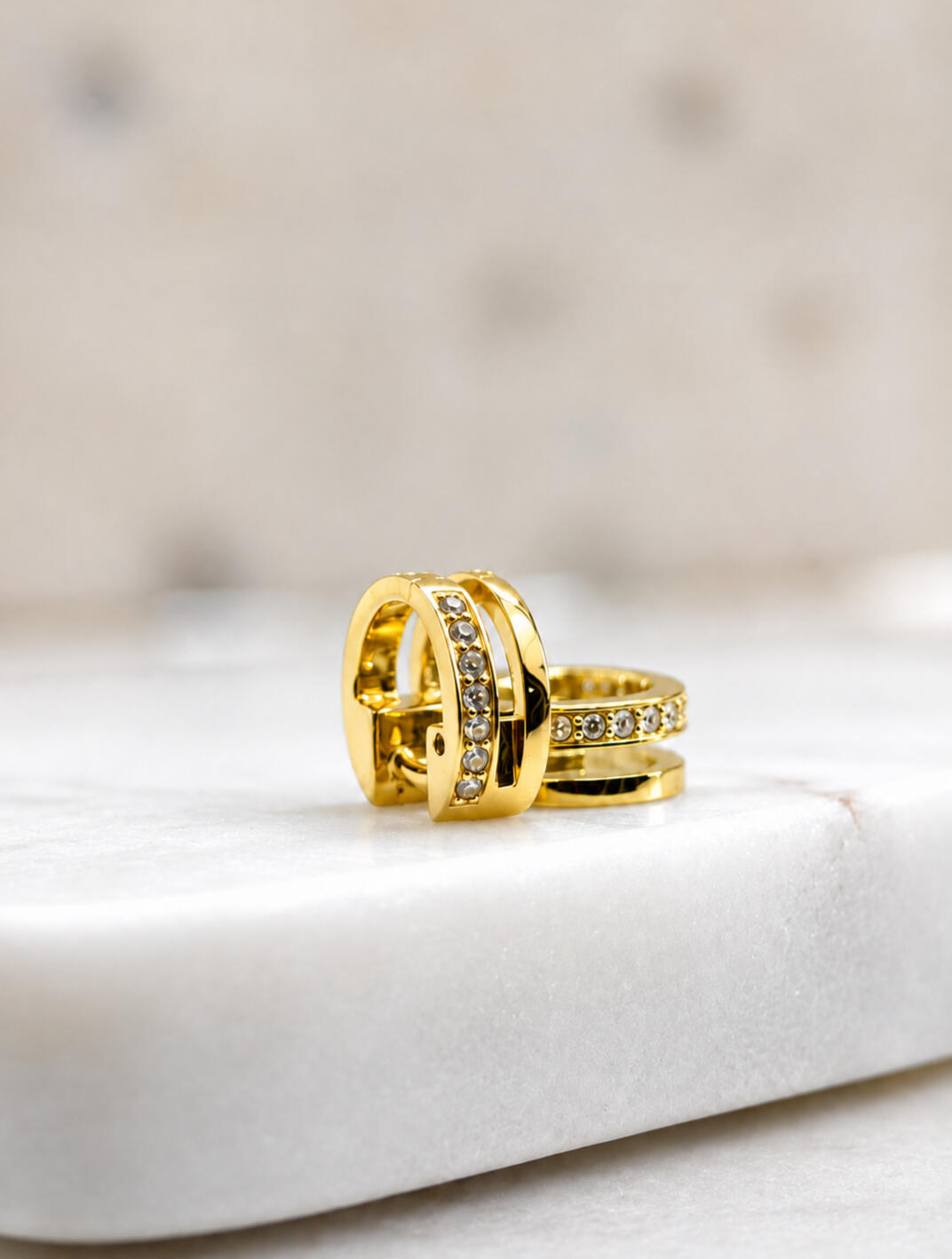 2 hair cuffs, gold and silver, on tiles