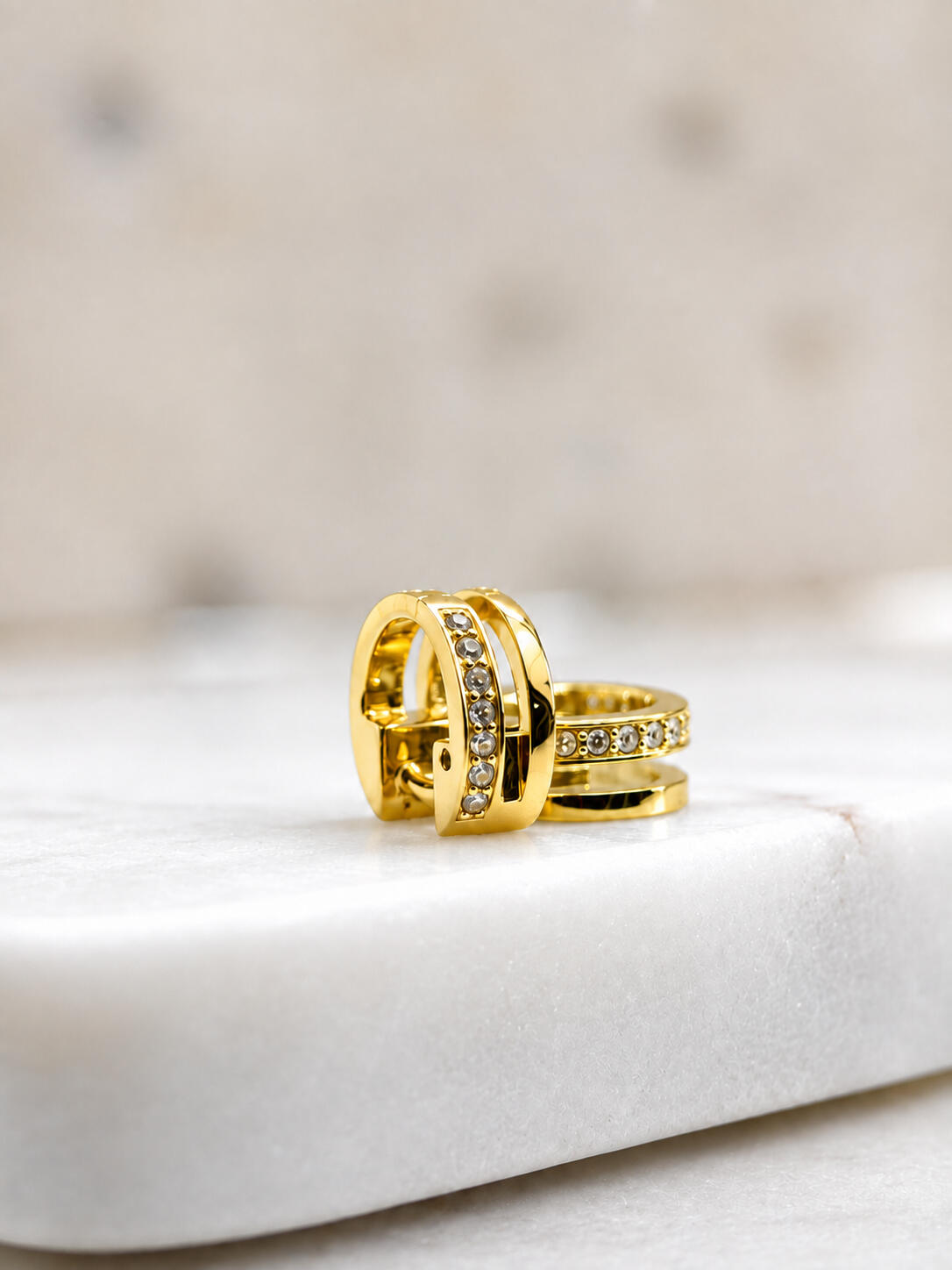 2 gold hair cuffs on tiles
