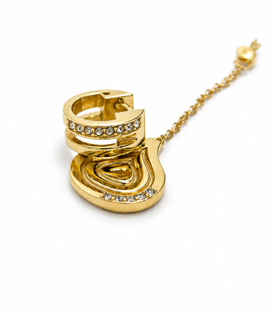 a gold hair cuff and pendant on white background