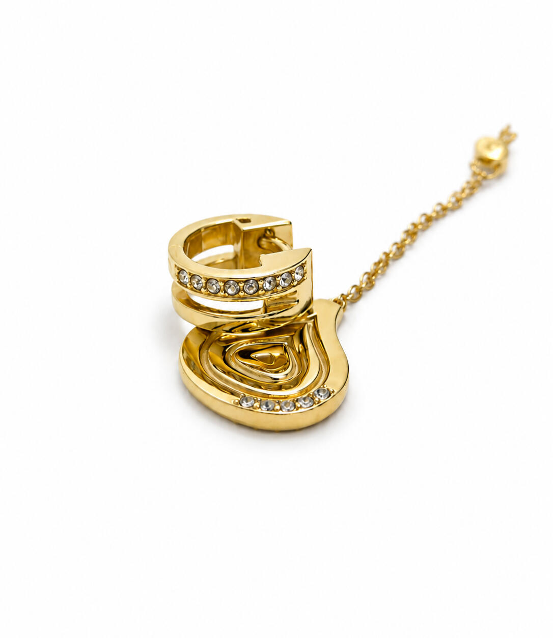 a gold hair cuff and pendant on tiles